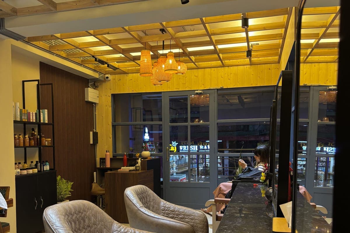 Inside Hair Official on Rishi Road, Kalimpong - product shelves, woven pendant lights and seating by the front windows